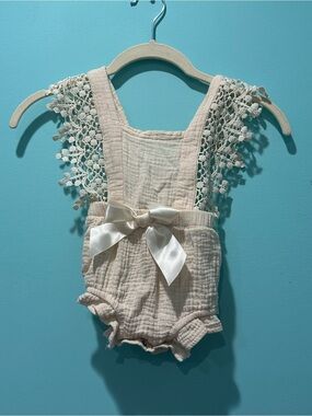 Delicate Cream Baby One-Piece Romper with Lace Straps and Satin Bow